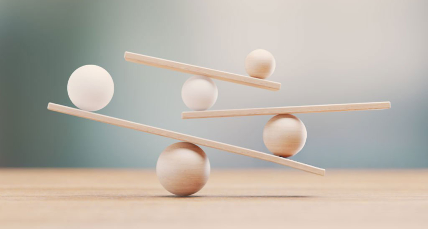 Illustration symbolisant l’équilibre entre bienveillance et cadre éducatif, avec des formes en bois en équilibre instable représentant les ajustements nécessaires en éducation.